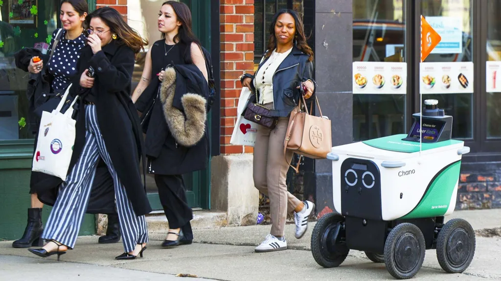 Robot de reparto autónomo circulando en una acera urbana